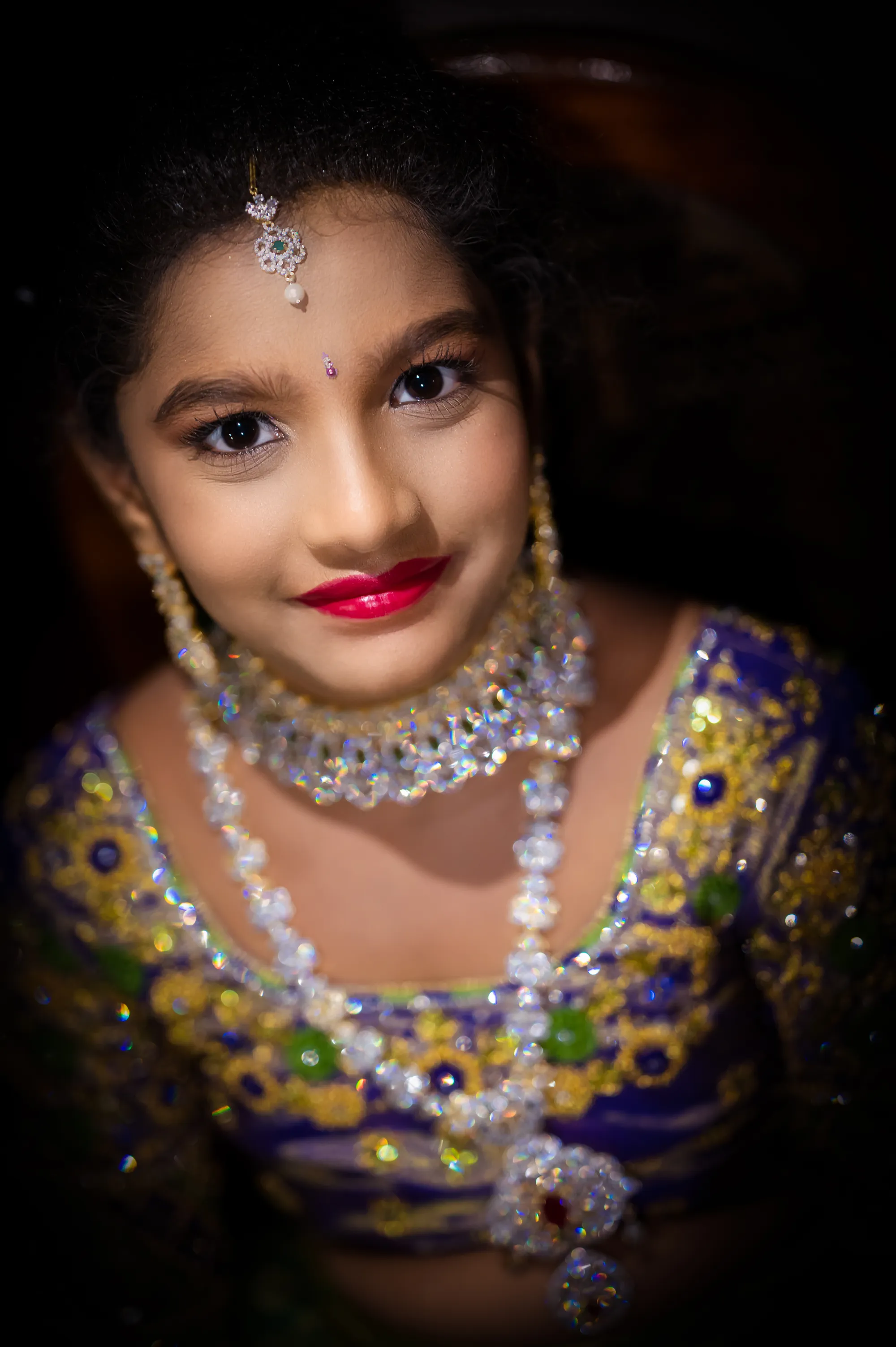 Shravya in a traditional emerald and maroon half saree