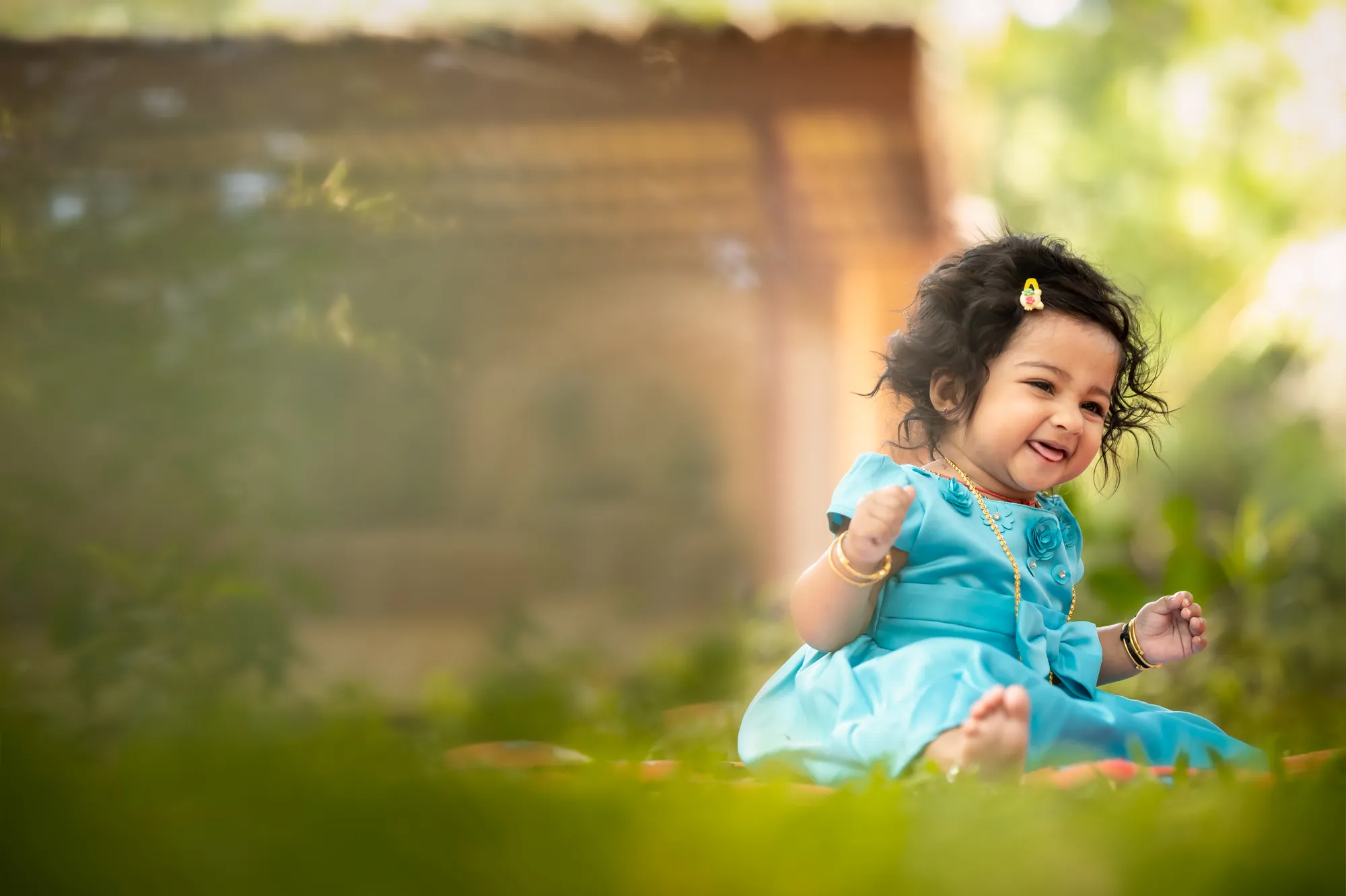 Aira blowing her first birthday candle in golden light